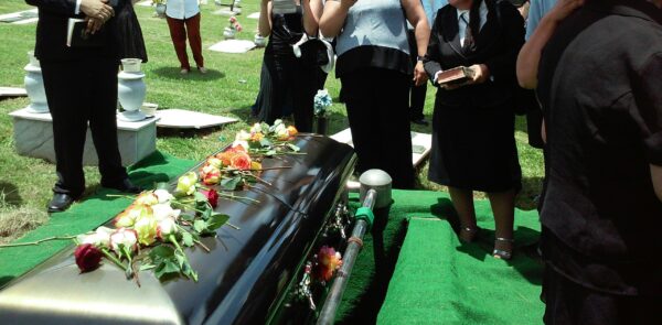 funeral expenses guide blog post which shows a casket being lowered into the ground