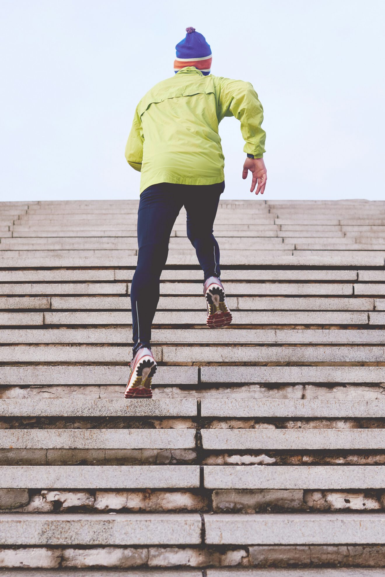 a man running up stairs, doing everything he can to keep moving forward and staying active