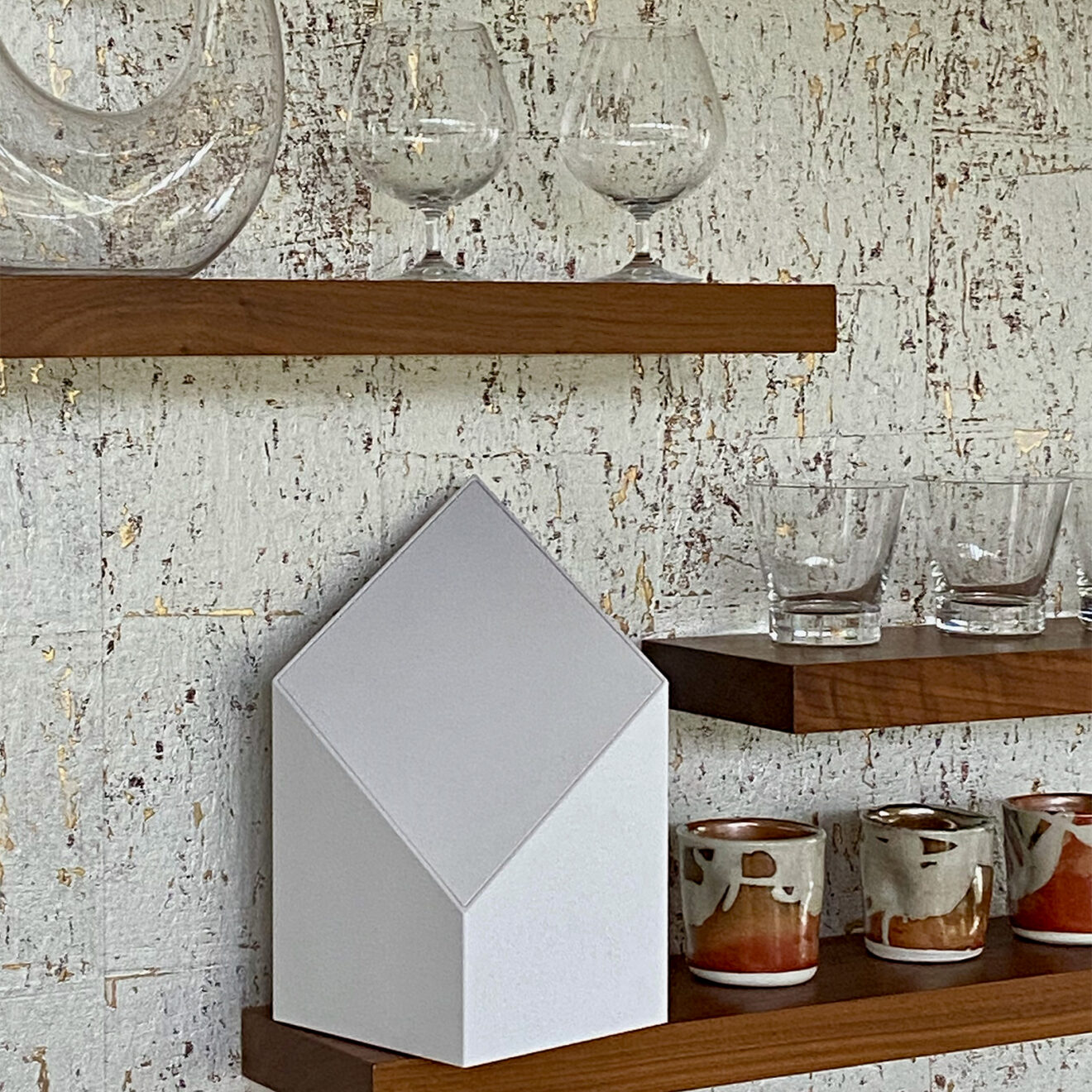 a picture of an urn on a shelf with glass, beautifully displayed and if you're looking for where to buy an urn, you've come to the right place