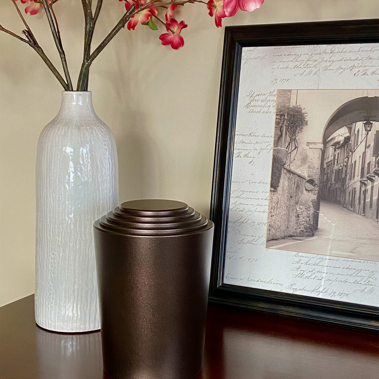 timeless series cremation urn on a table next to some flowers and a picture