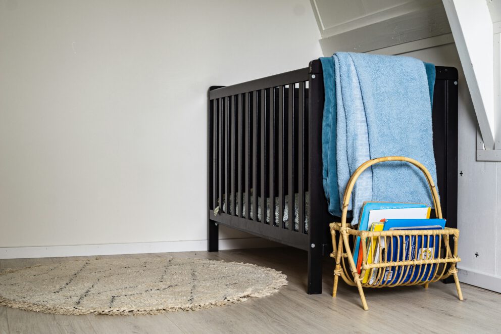 an empty crib in the corner of the room