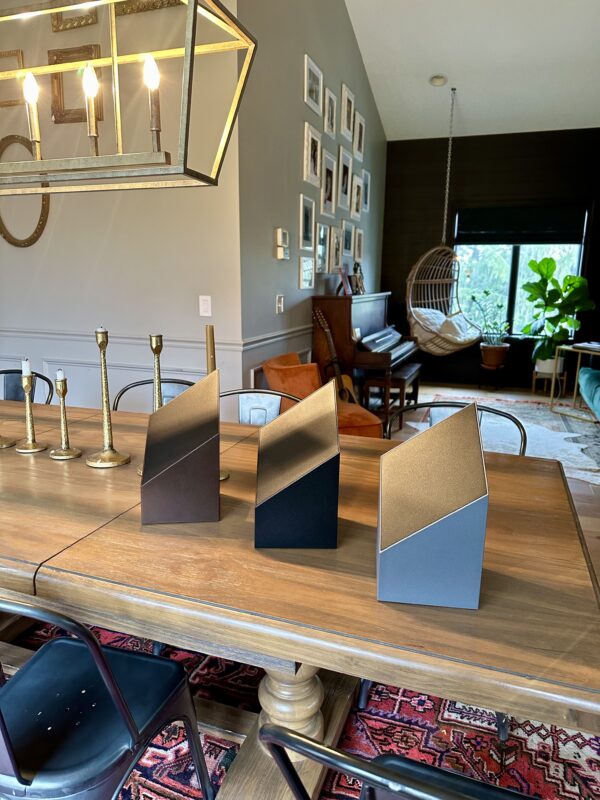 modern cremation urns showcased on a table in the dining room of a beautifully designed home
