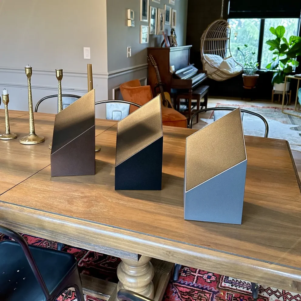 modern cremation urns showcased on a table in the dining room of a beautifully designed home